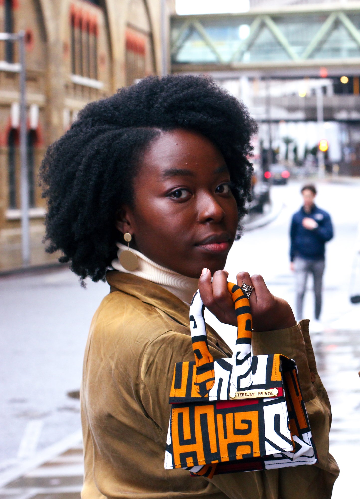 Girl holding down and white African Print Mini Bag