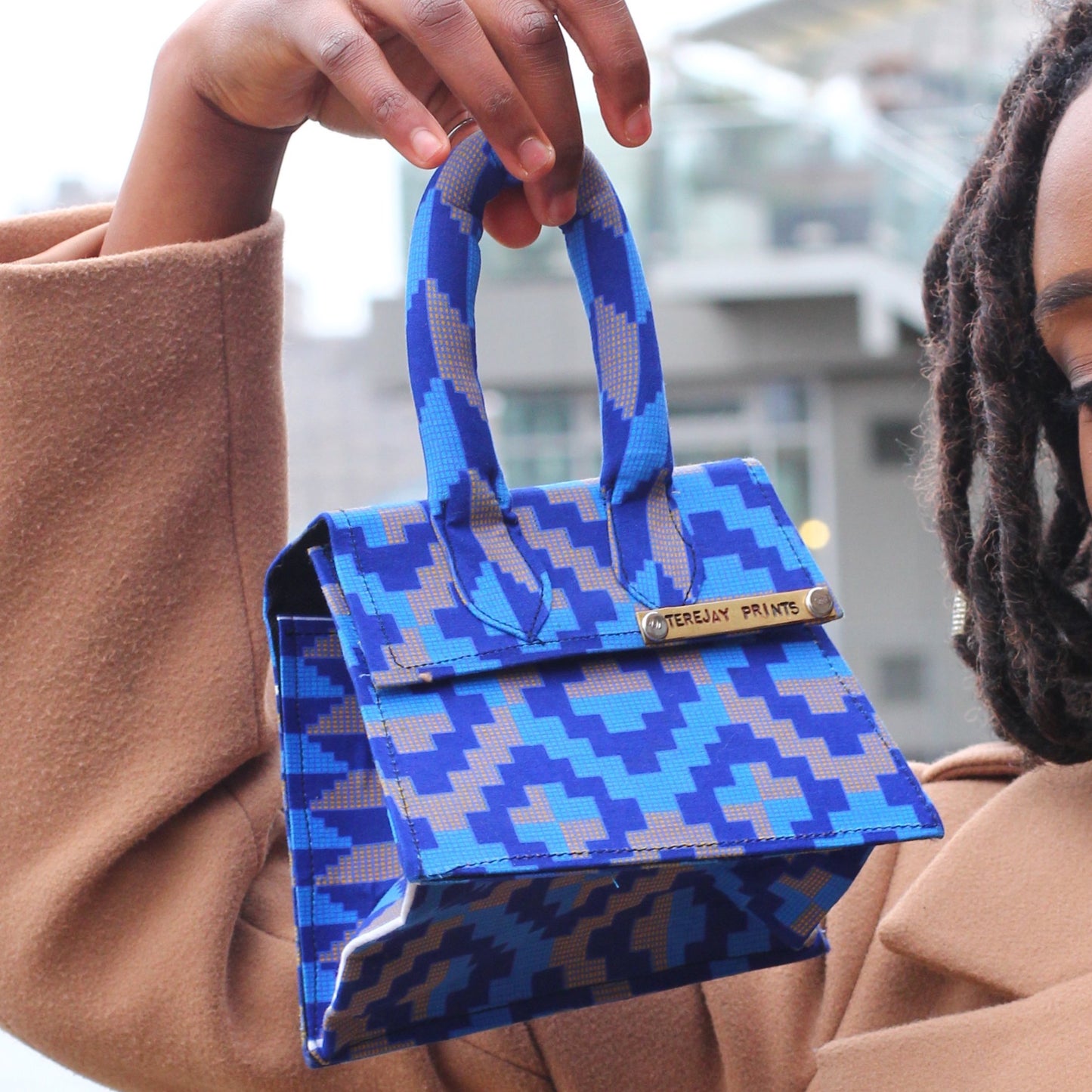 Girl holding blue Ankara / African Print Mini bag