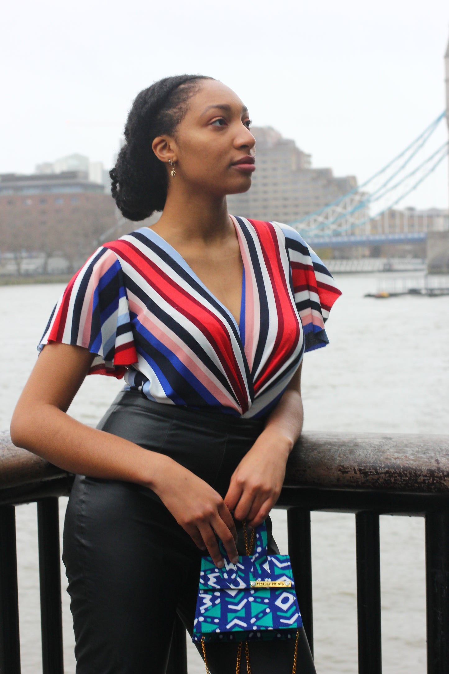Girl holding blue African Print Mini Bag